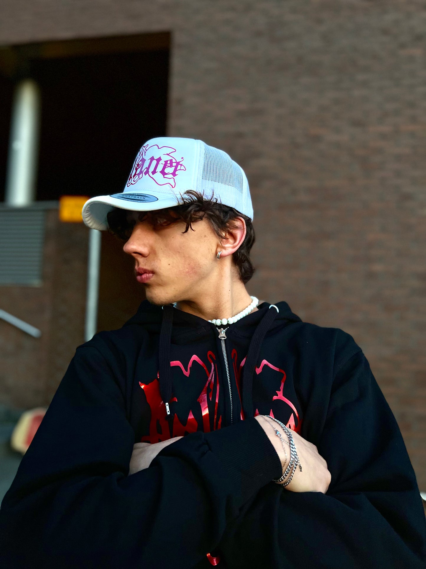 White trucker cap with pink logo