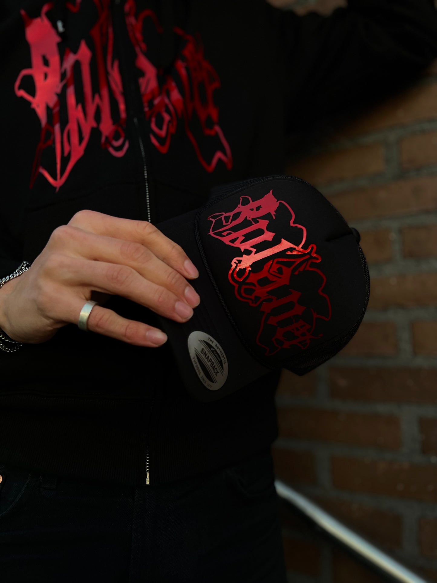 Black trucker cap with red logo