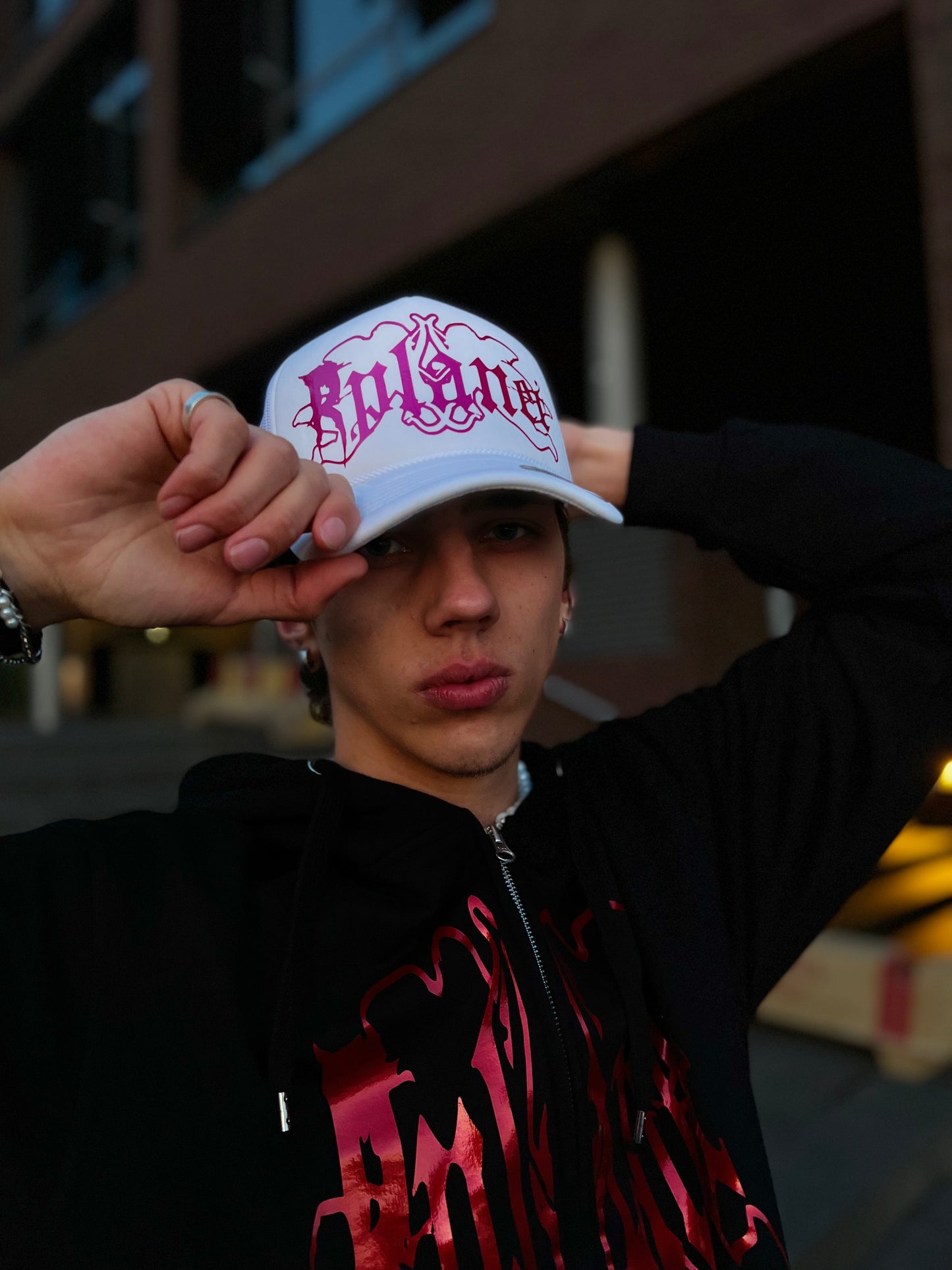 White trucker cap with pink logo