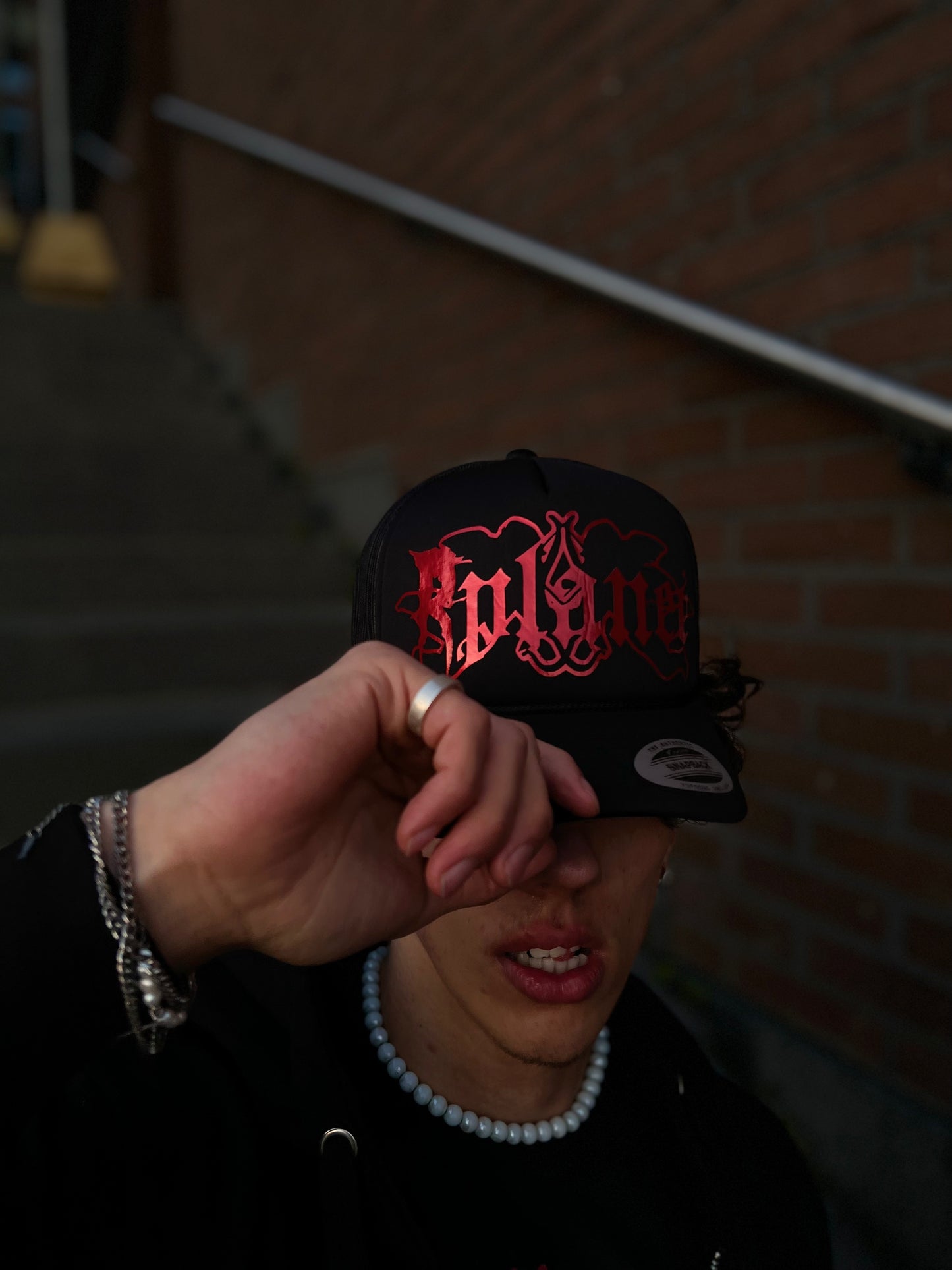Black trucker cap with red logo